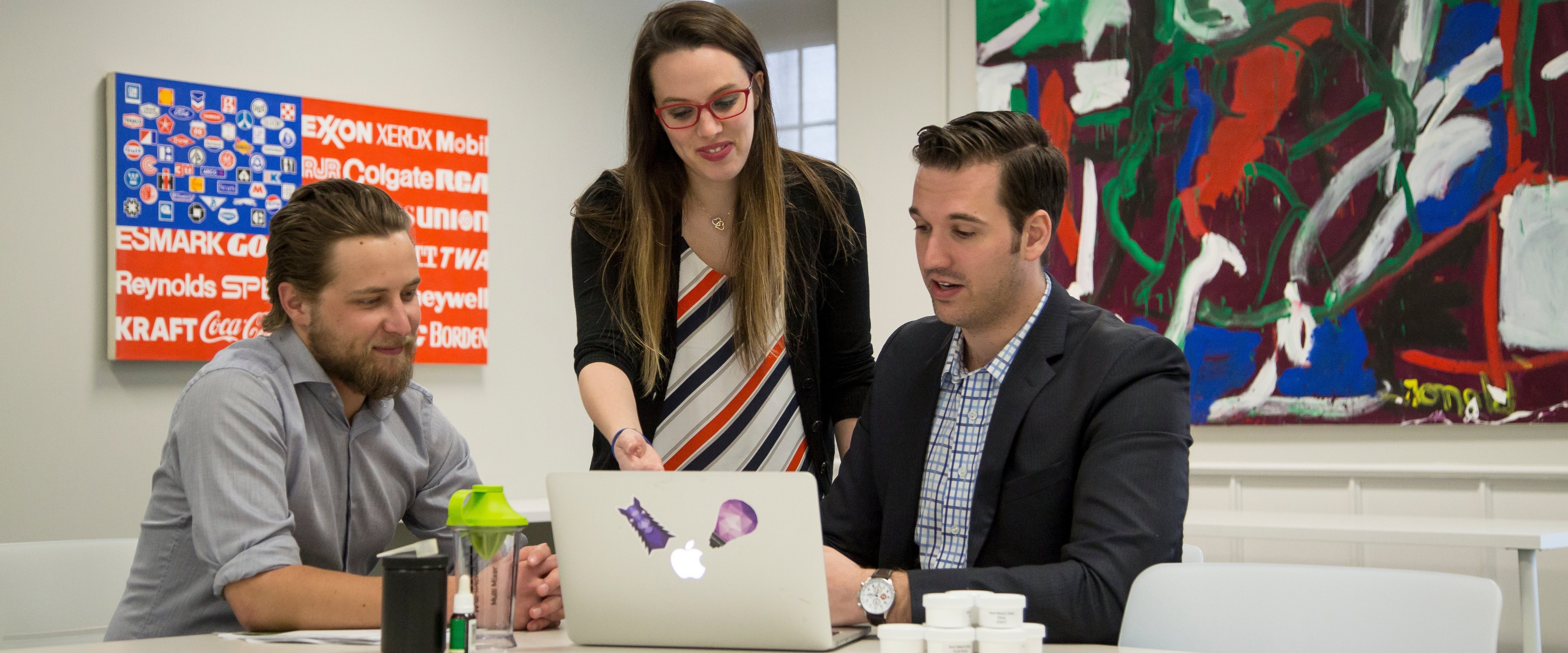 Two students being advised by a business analyst