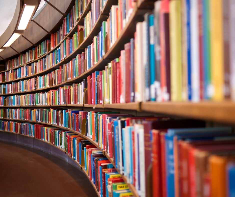 Collection of library books on wall to floor shelves