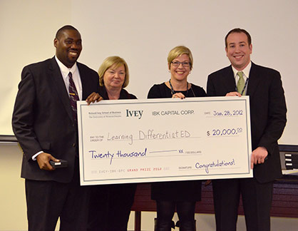 Team Learning DifferentiatED holding winning cheque from MBA Ivey Business Plan Competition 2013